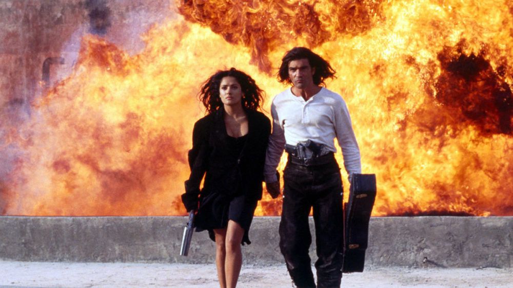Salma Hayek and Antonio Banderas walking away from an explosion in Desperado (1995)