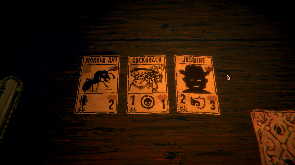 Three cards lie on a wooden table: one labeled worker ant, one labeled cockroach, and one labeled Jasmine.