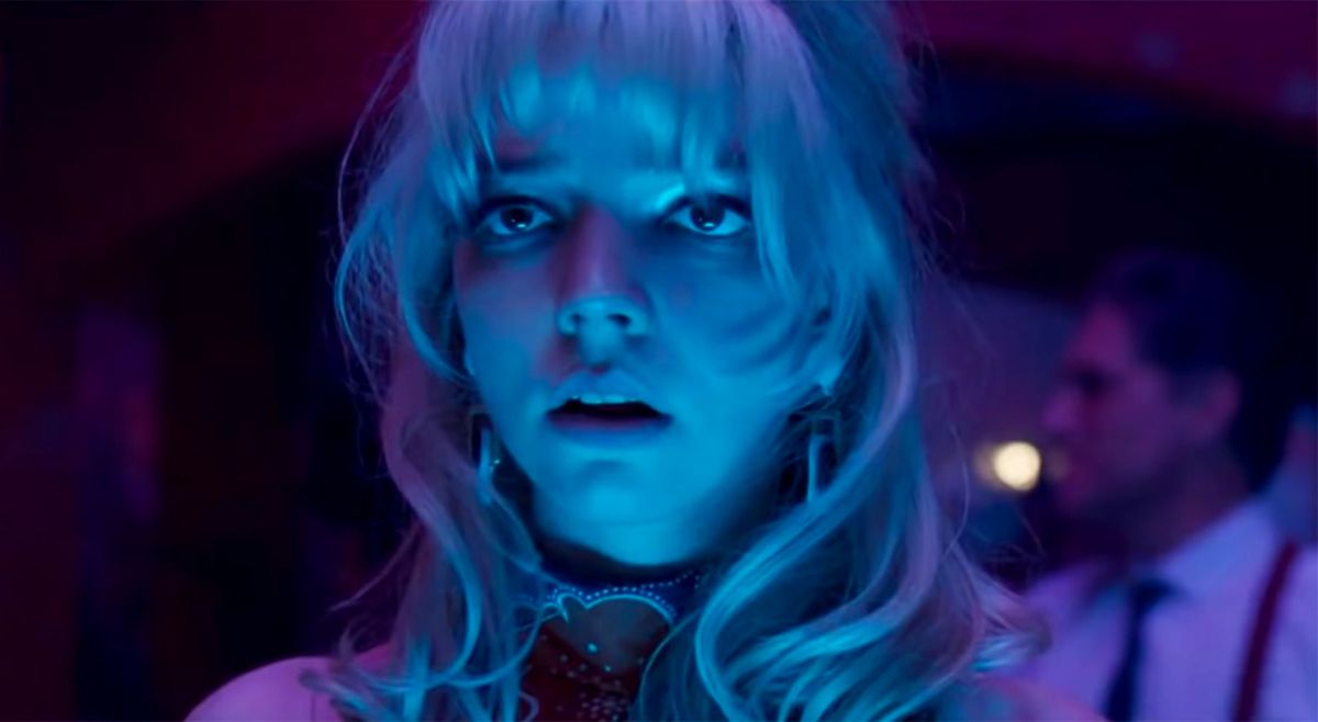 Anya Taylor-Joy, lit in neon blue and terrified, in Last Night in Soho