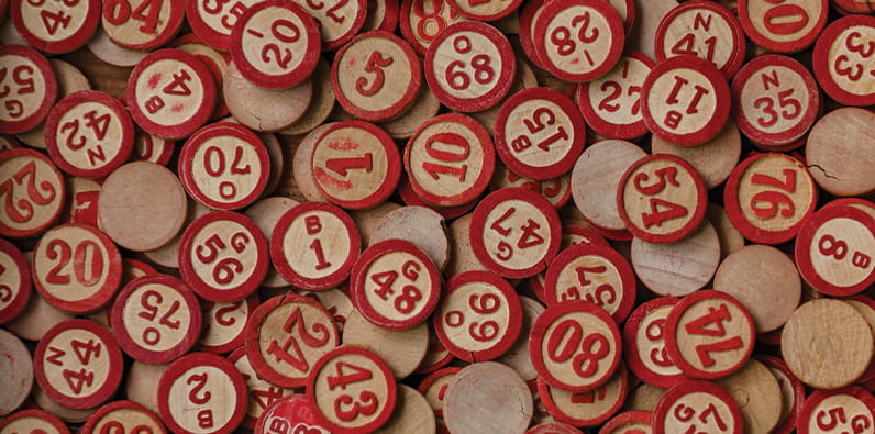 Many Bingo Numbers Laying On a Table
