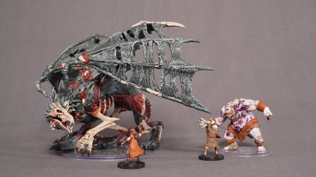 Two heroes (from the Legends of Barovia set) battle a Green Dracolich and an Ogre Zombie.