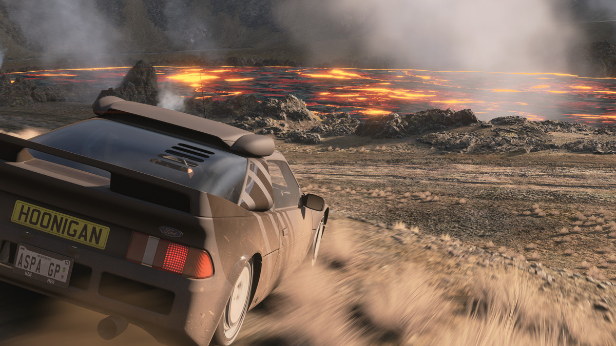A rally car in the foreground looking out over a steaming lake of glowing hot magma