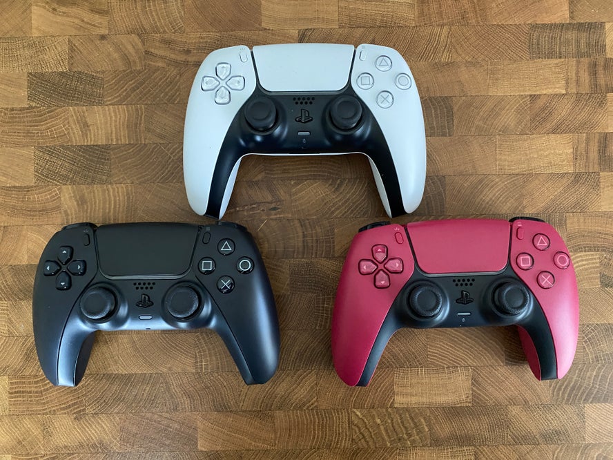 The three DualSense colors: White, Midnight Black, and Cosmic Red