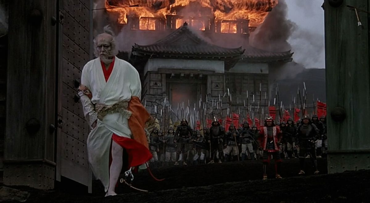 Lord Hidetora Ichimonji walks dejectedly from his burning estate