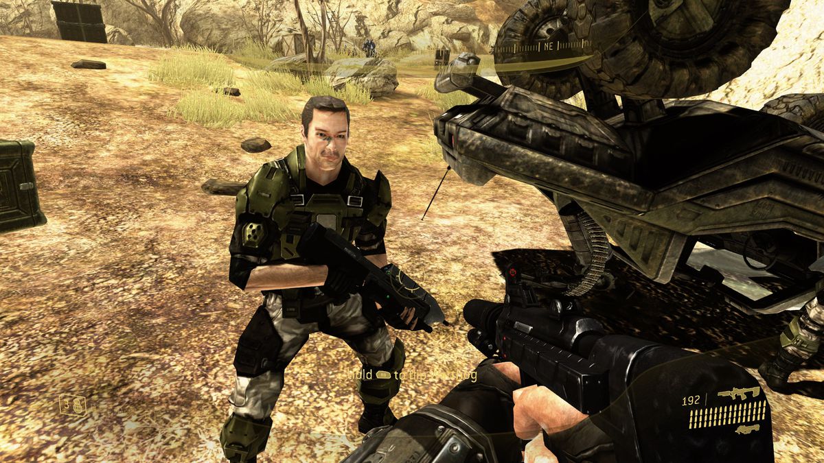 A soldier stands facing the player, showing off their gear