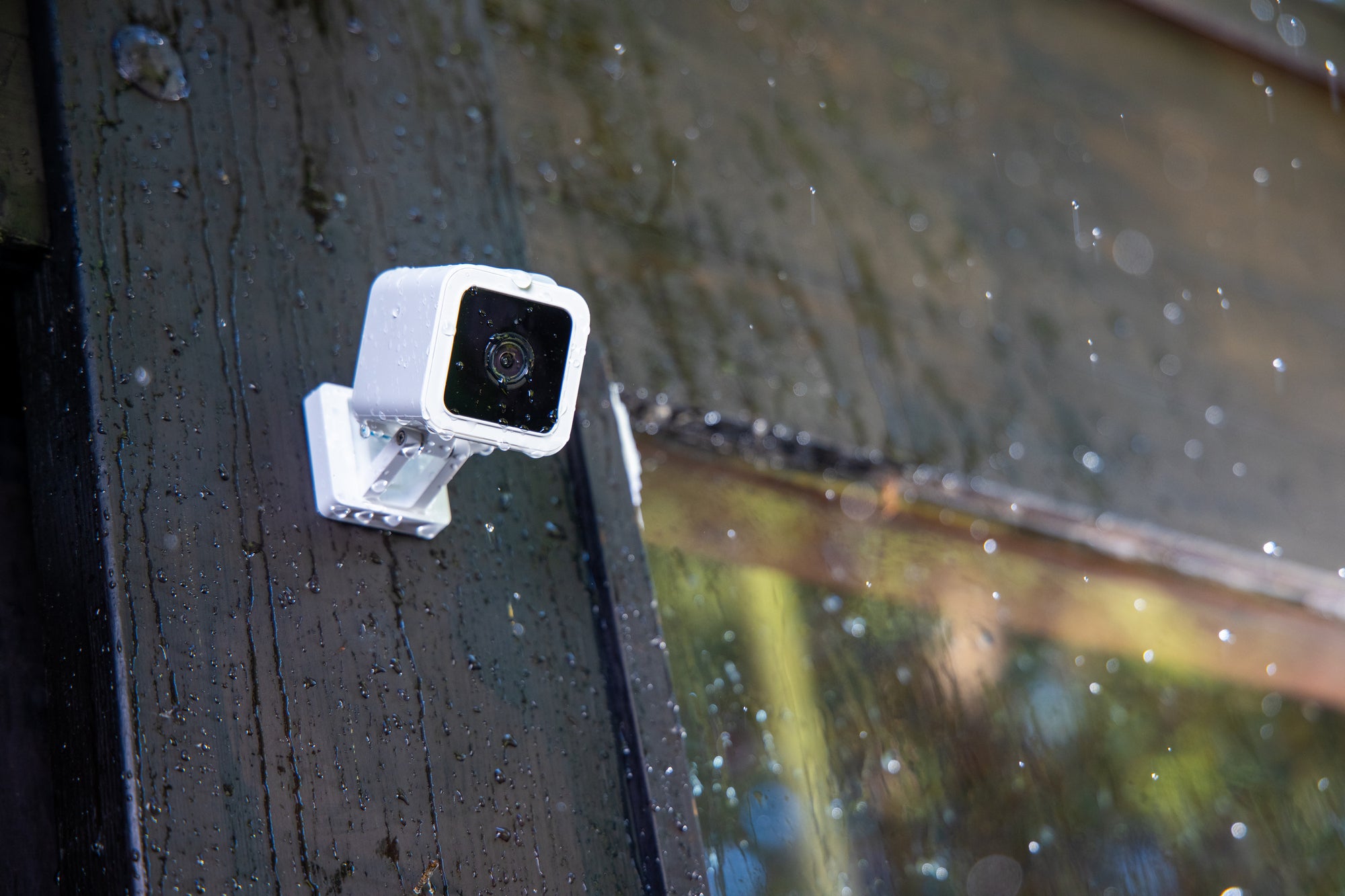 Wyze cam mounted to the side of a wood building