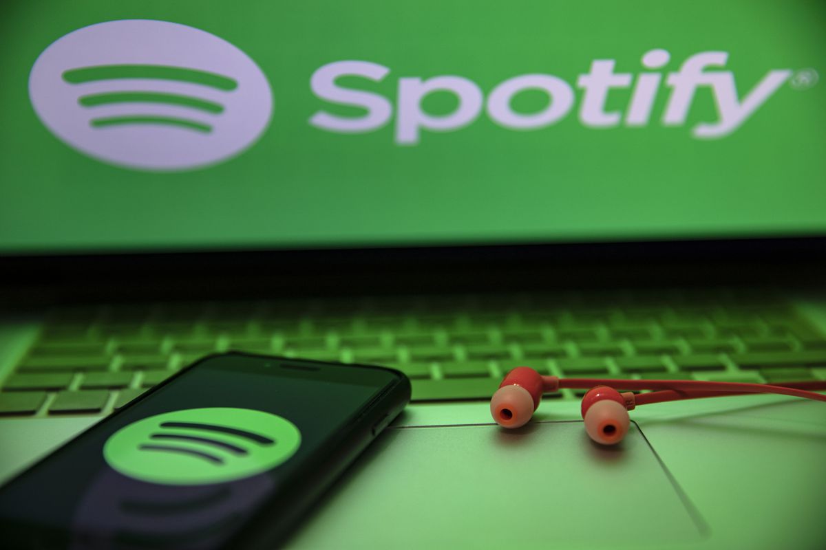 In this photo illustration the Spotify logo seen displayed...