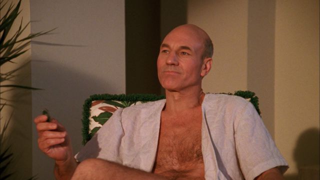 Picard reclining in a chair with an open shirt