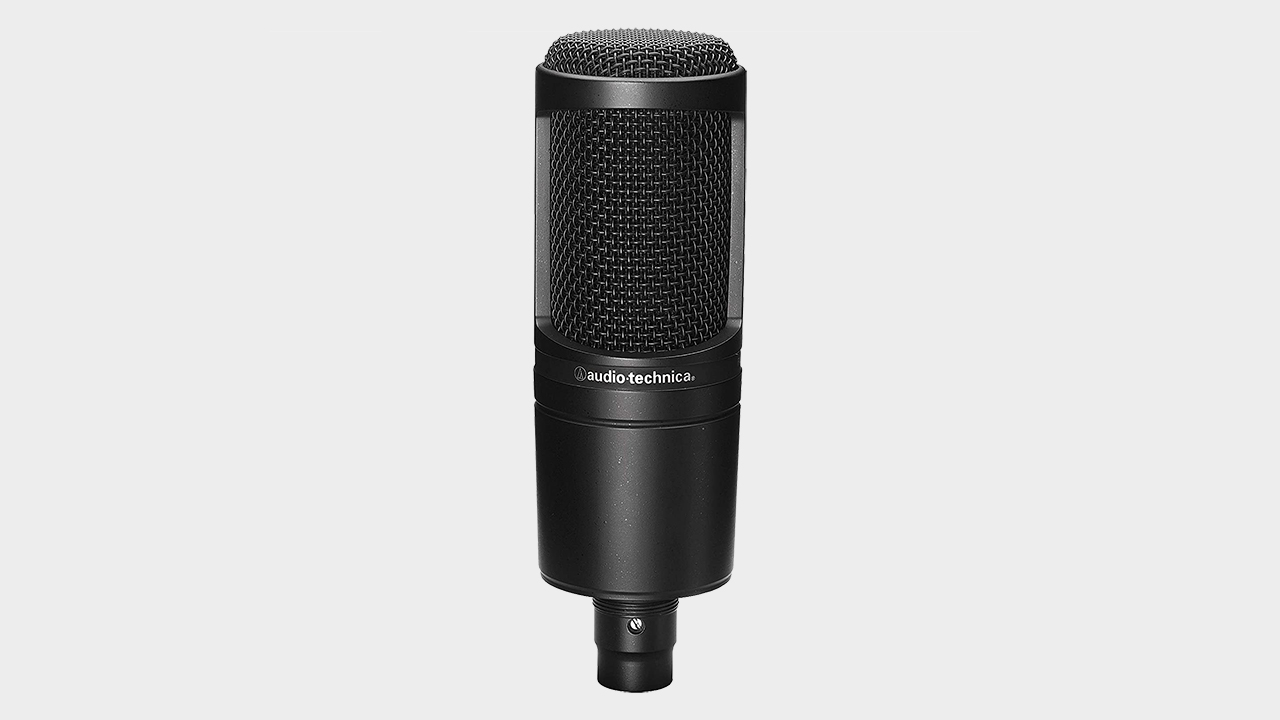 AT2020 microphone in front of gray background.