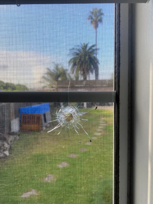 Damage of stray bullet in gamer's bedroom.