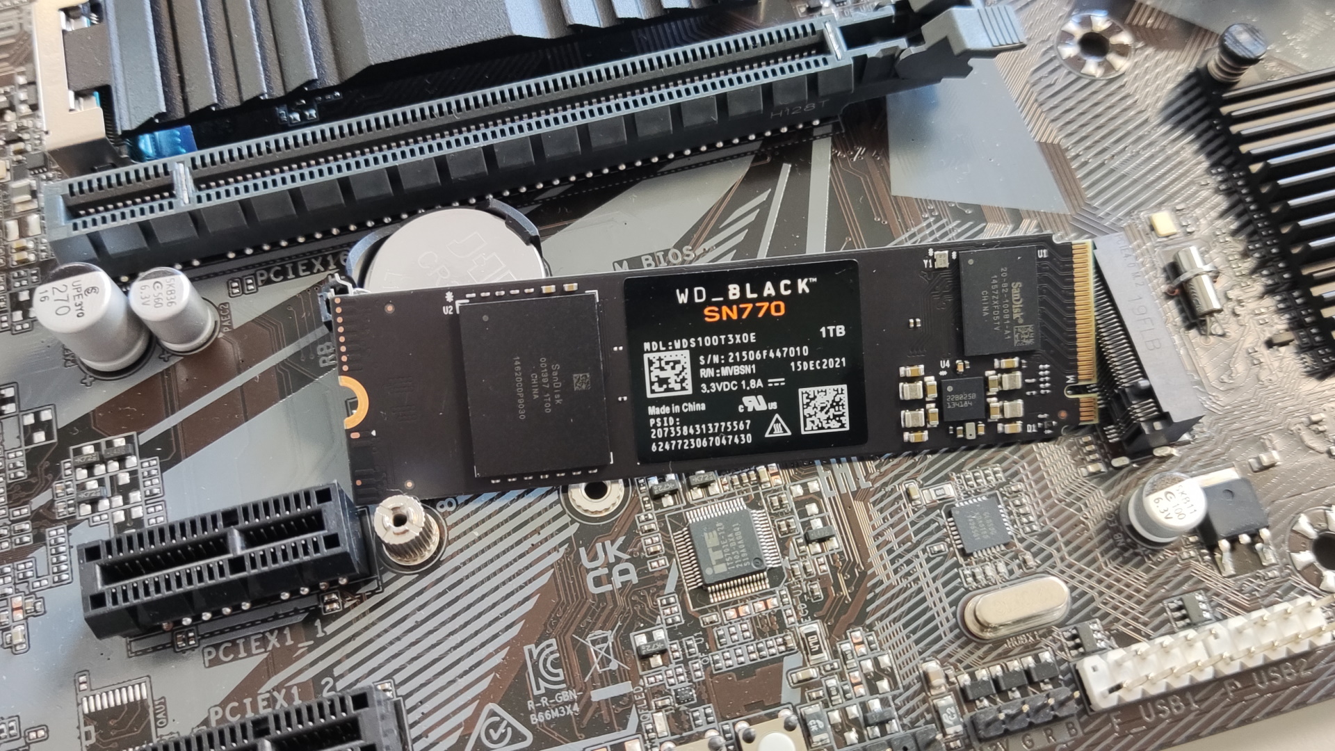 Western Digital WD Black SN770 resting on a motherboard.