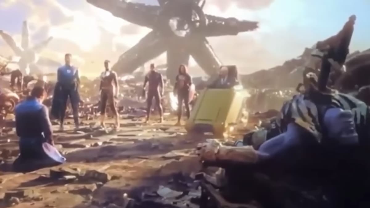 Illuminati standing on Titan with defeated Thanos