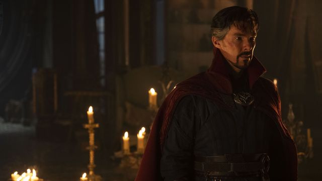 Benedict Cumberbatch as Doctor Strange standing in front of a bunch of candles and looking super duper extra broody in Doctor Strange in the Multiverse of Madness.