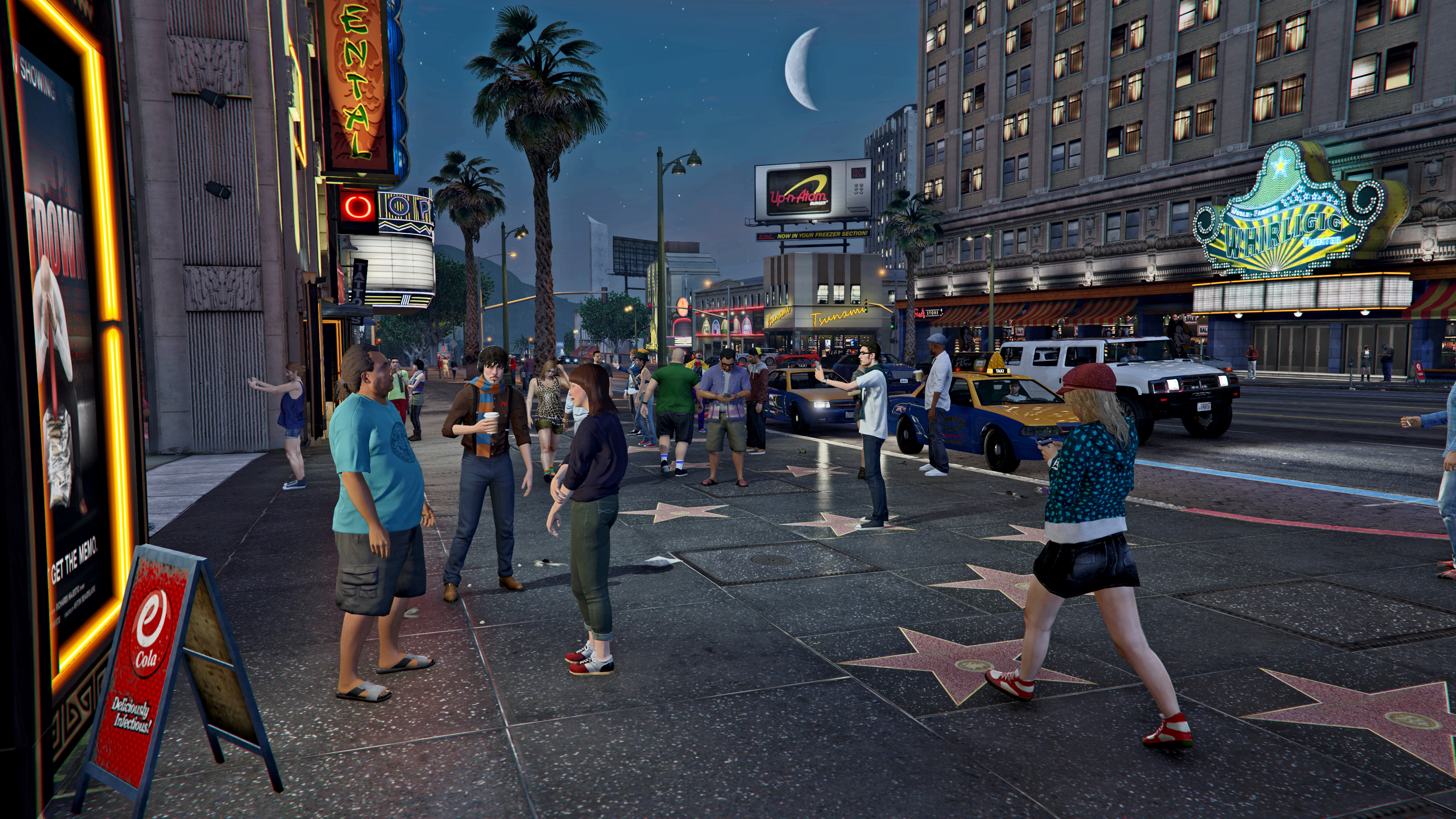 Best co-op games - Grand Theft Auto Online - A city street full of characters walking past Hollywood-style stars in the sidewalk at night