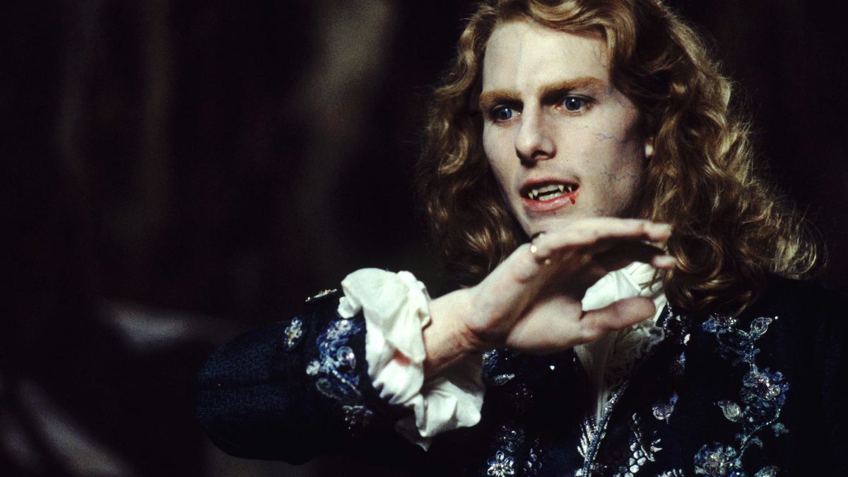 Tom Cruise as Lestat in Interview With the Vampire, with long curly blond hair and blood dripping from his fangs
