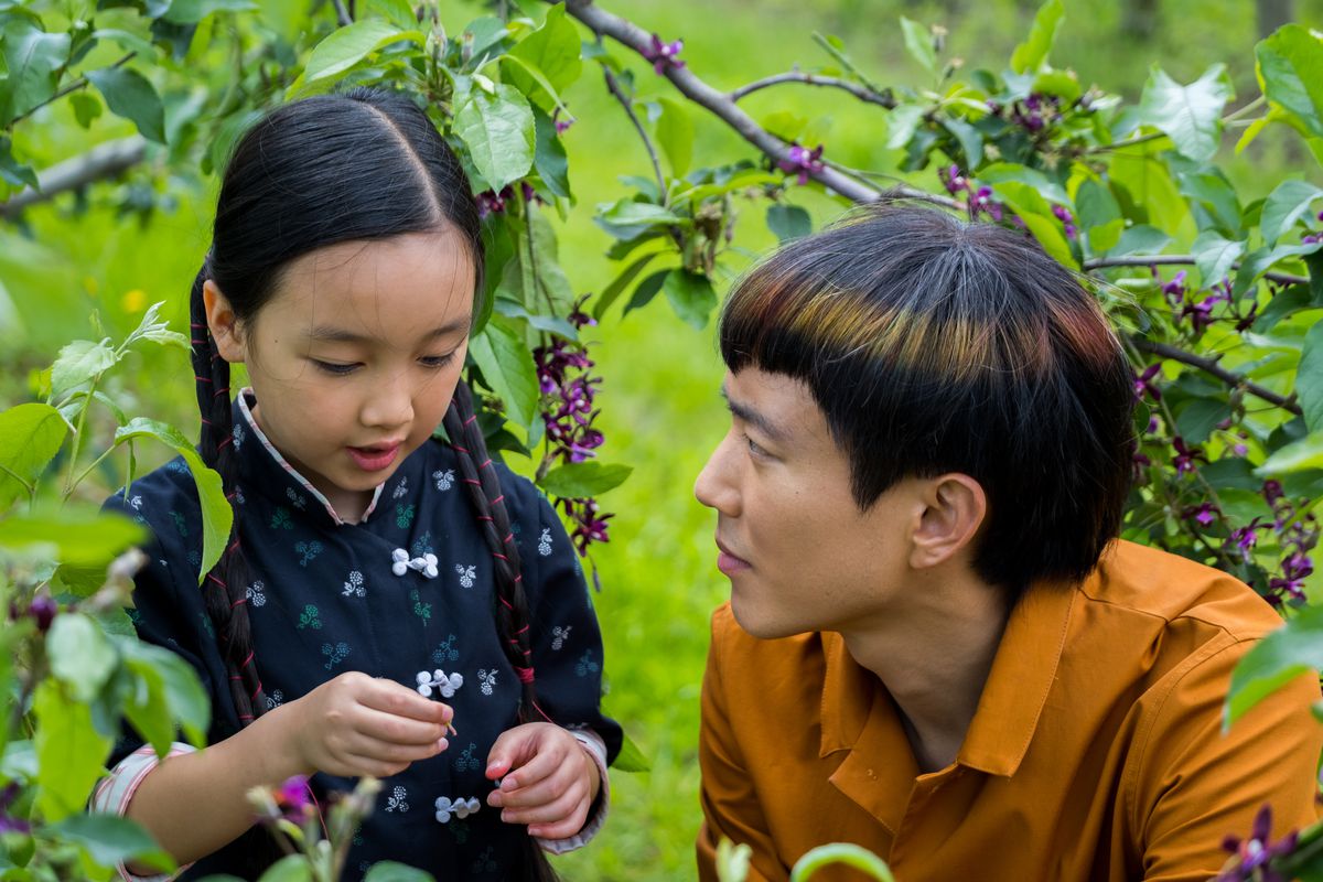 Justin H. Min as android “big brother” Yang looks after Mika (Malea Emma Tjandrawidjaja) in an orchard in After Yang