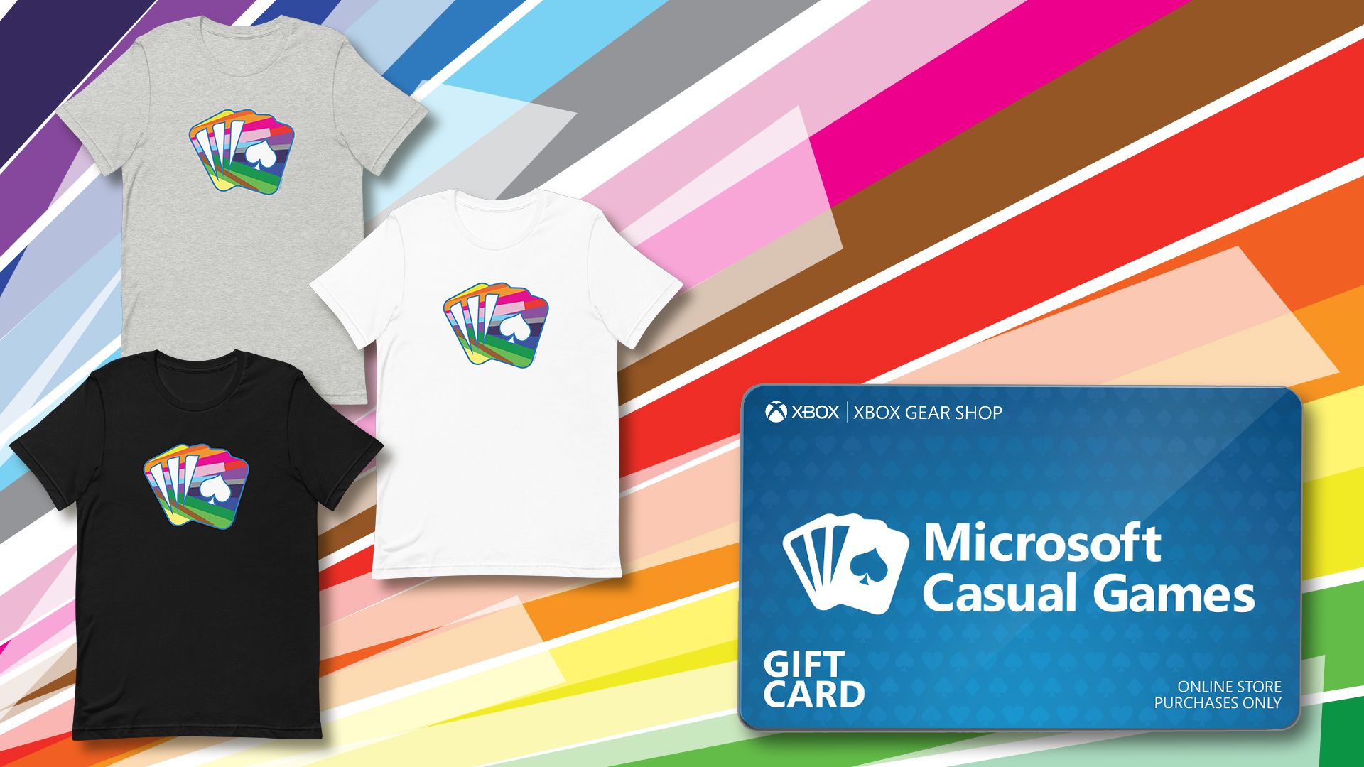 배경은 각진 색상의 광선으로 채워집니다. 새로운 Microsoft Causal Games 프라이드 로고가 있는 검정, 회색 및 흰색 3개의 티셔츠가 왼쪽에 표시됩니다. Xbox Gear Shop 기프트 카드는 오른쪽에 있습니다.