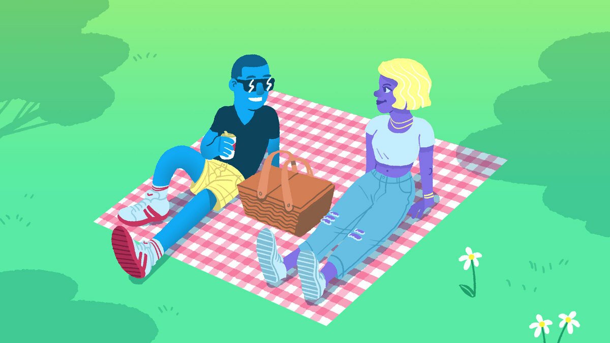 two people sitting on a picnic blanket