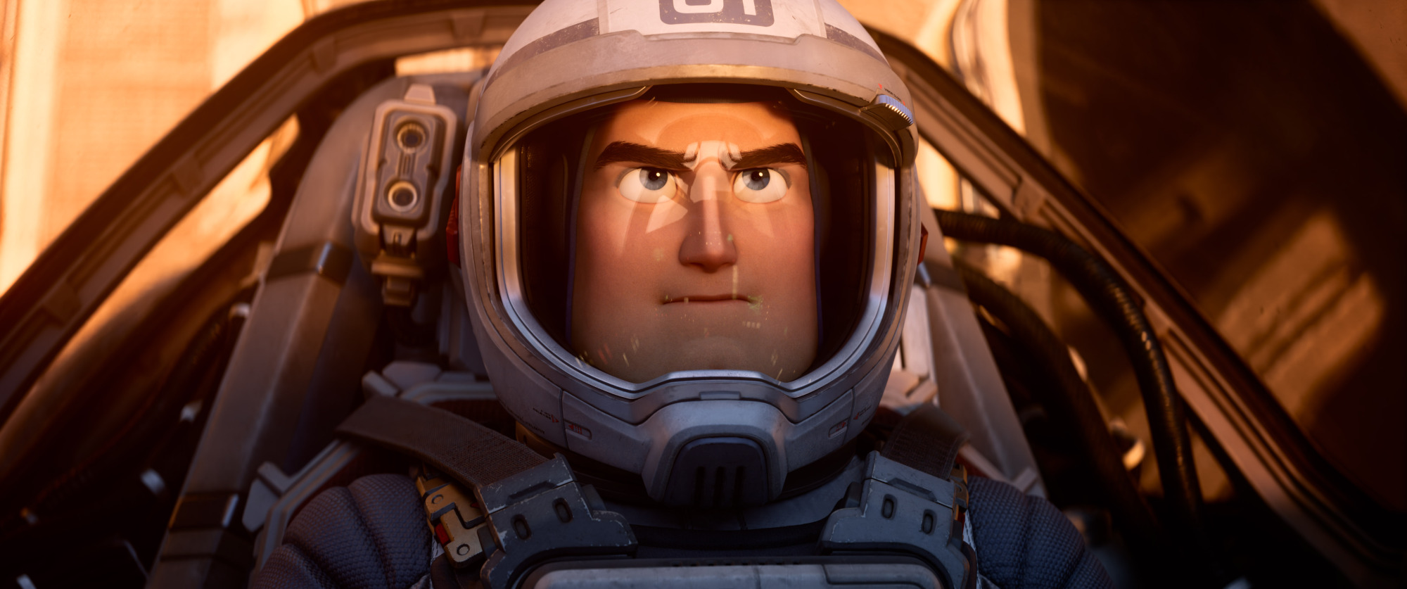 A man in a spacesuit sits in the cockpit of a spaceship.