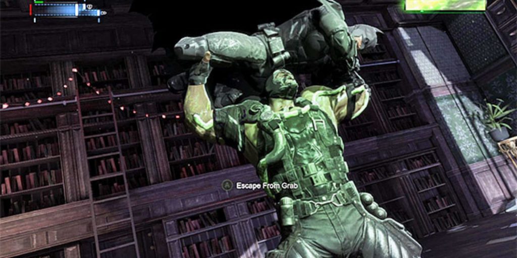 Bane lifts Batman over his head in the iconic back breaking pose