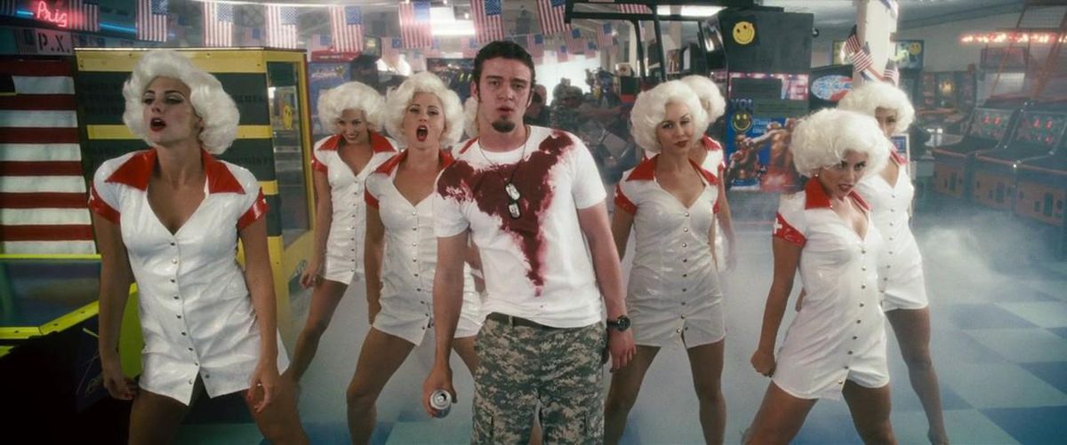 Justin Timberlake performs with backup dancers in a bloody white t-shirt in Southland Tales.