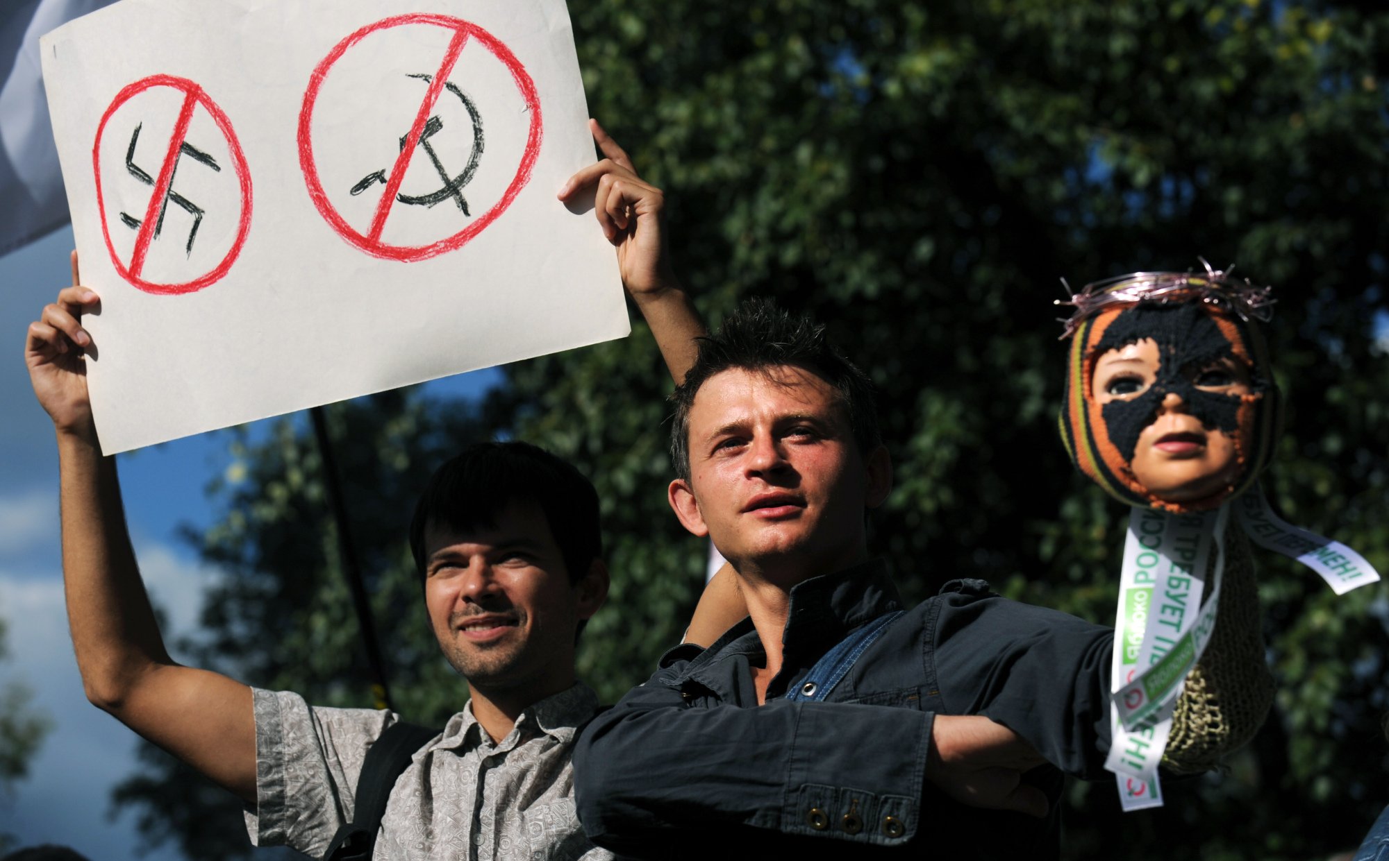 No to fascism, no to communism: Russian opposition supporters hold a puppet's head wearing a balaclava, trademark of the feminist punk band Pussy Riot, during a commemorative event for the victims of the 1991 coup in Moscow on Aug. 19, 2012