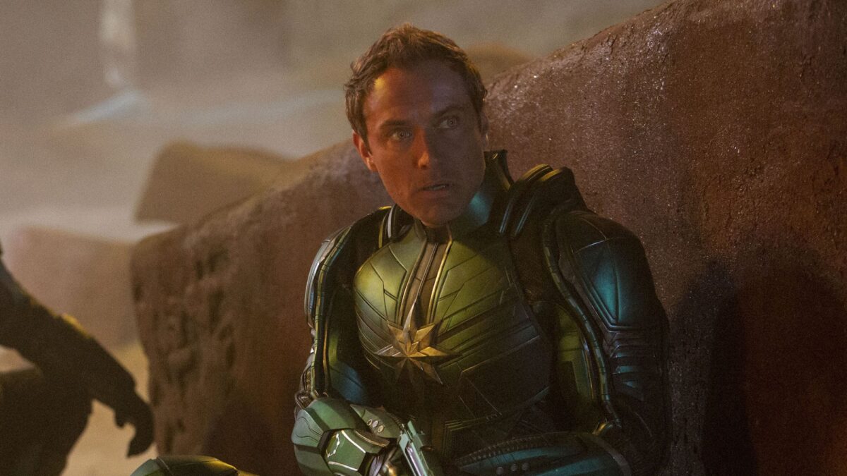 A man in a green metal alien suit with his head exposed: Jude Law as Yon-Rogg in "Captain Marvel."