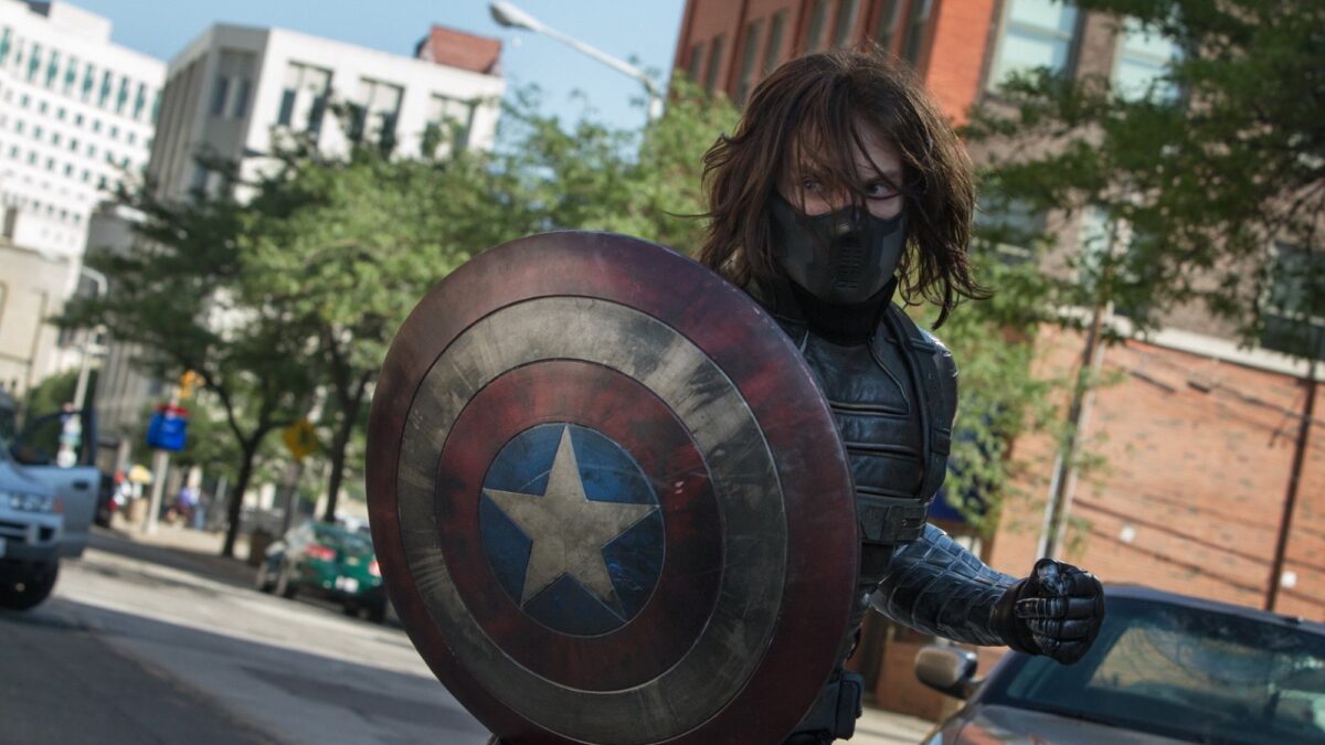 Bucky Barnes (Sebatian Stan) as the winter soldier; masked, armed, and holding Captain America's shield to use against him as a weapon.