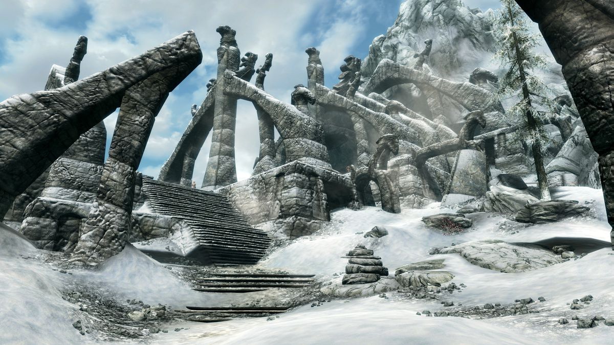 A dark granite structure emerging from the snow on a distant mountain peak in The Elder Scrolls 5: Skyrim