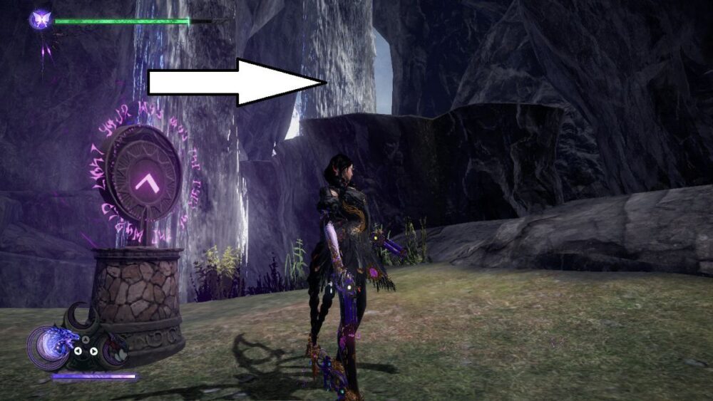 Bayonetta stands in a cave behind a waterfall next to a pendant in Bayonetta 3.