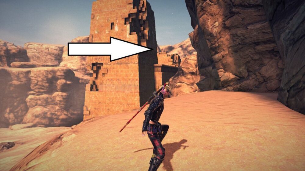 Viola stands in front of a tower in the middle of a desert in Bayonetta 3.