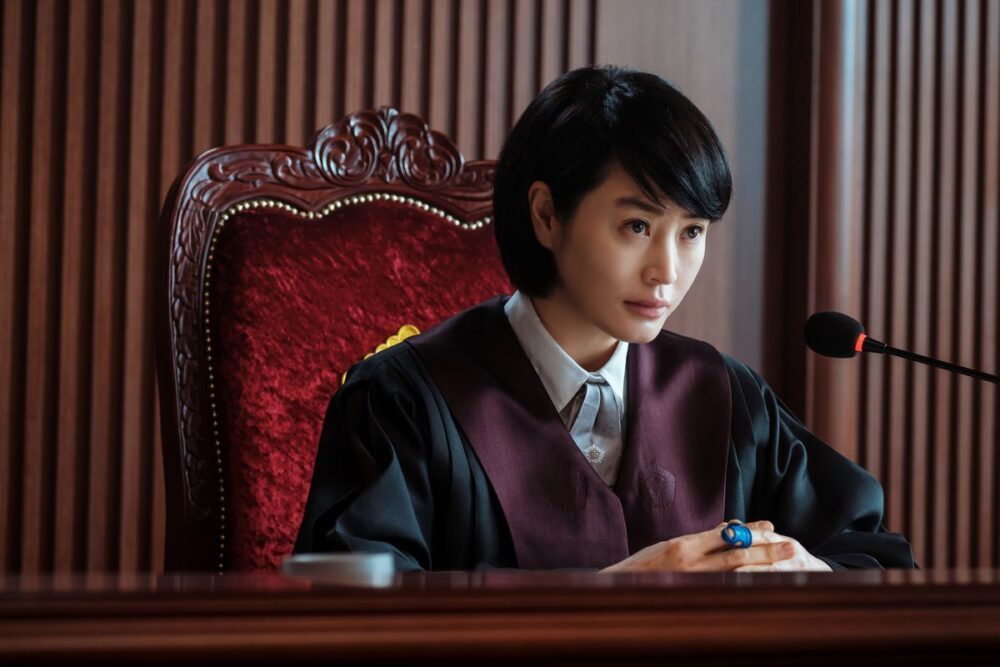 Kim Hye-soo wears judge’s robe and sits in a big red chair in Juvenile Justice.
