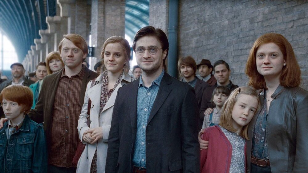 adult Harry, Ron, Hermione, and Ginny watching their kids board the Hogwarts Express at the end of Harry Potter and the Deathly Hallows: Part 2