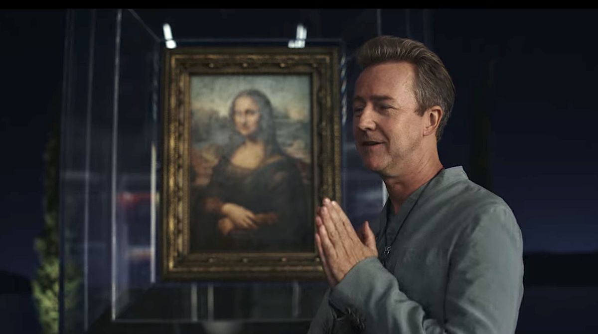 Billionaire Miles Bron (Edward Norton) stands in front of the Mona Lisa with his hands folded in Glass Onion