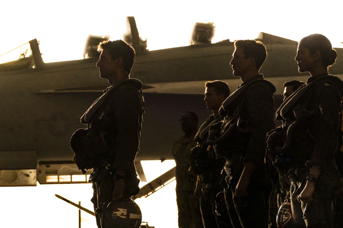 Maverick stands in profile with his class of young bucks in a hella dramatic sunset shot for Top Gun: Maverick