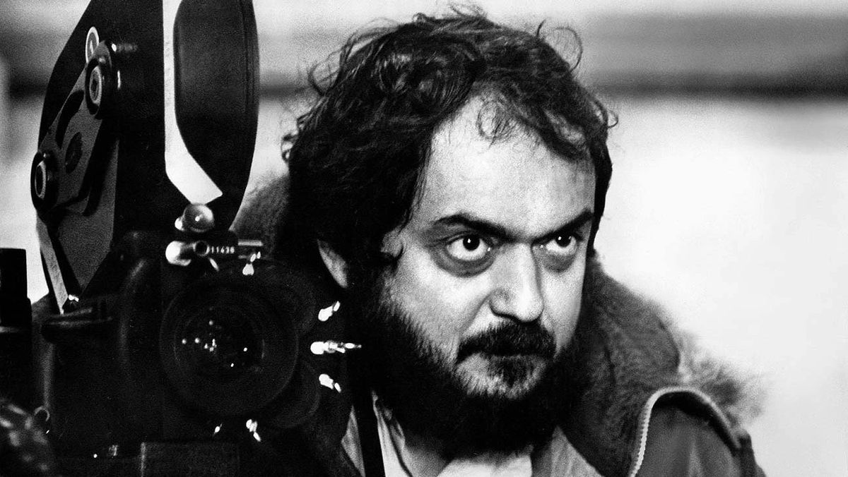 An archival photo of a bearded Stanley Kubrick behind a camera