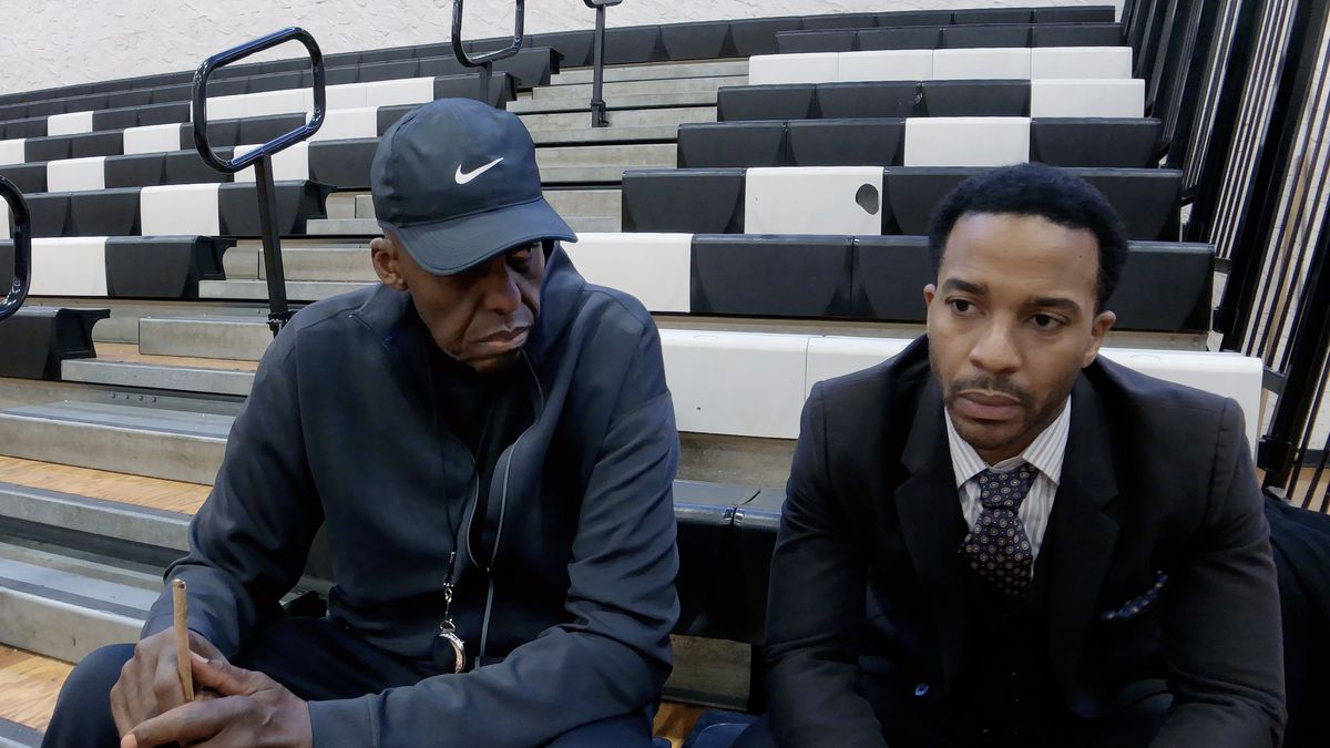 Bill Duke and André Holland sit on the bleachers in High Flying Bird.