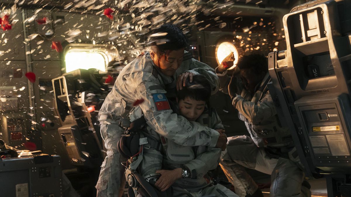 (L-R) Wu Jing, Wang Zhi and Kawawa Kadichi shielding themselves from shattered glass from an explosion in The Wandering Earth 2.