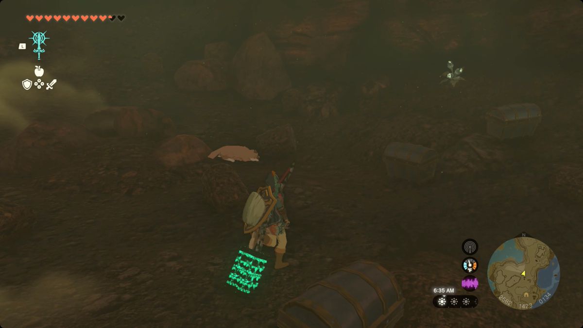 The Legend of Zelda: Tears of the Kingdom Link and his new dog friend in Cephla Lake Cave. The dog is laying down and pointing at a half-buried treasure chest.