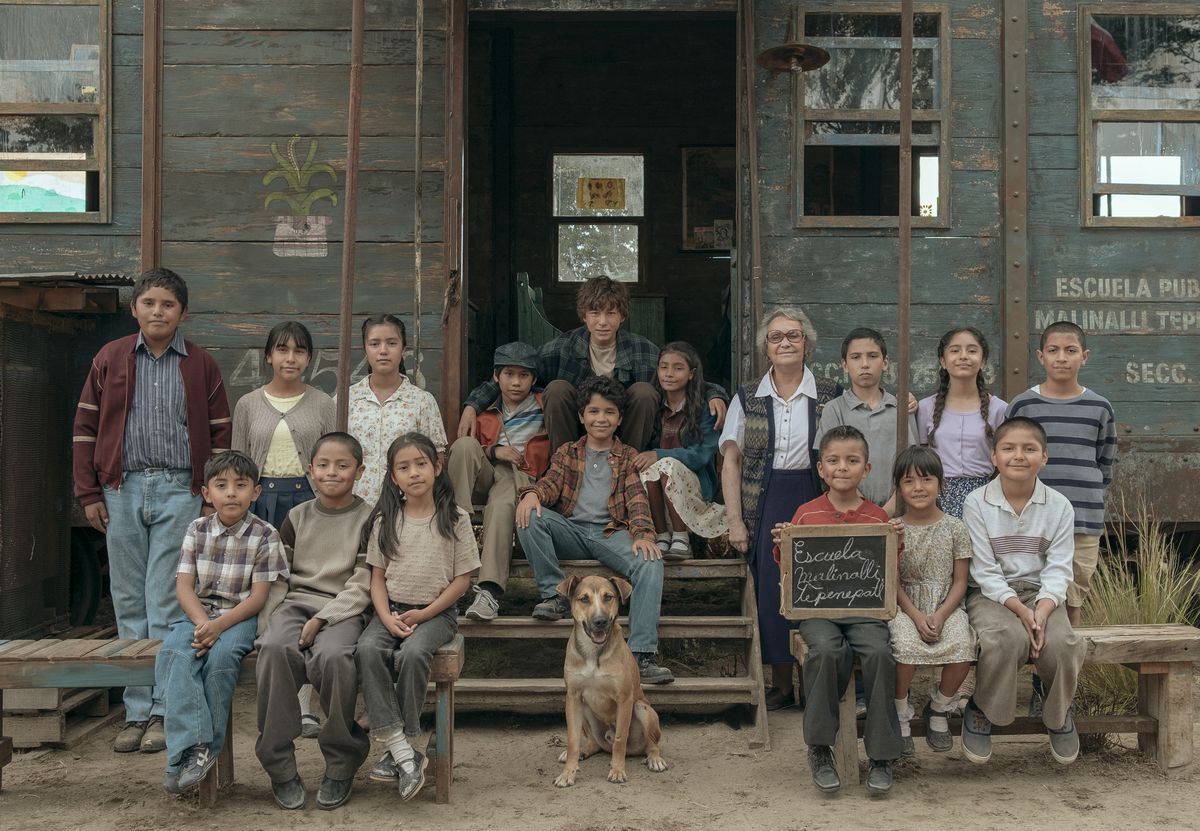 (L to R) A picture of a children in front of a makeshift school house, including Ikal Paredes, Frida Sofía, Karlo Barría, Adriana Barraza in the foreground in Where the Tracks End.