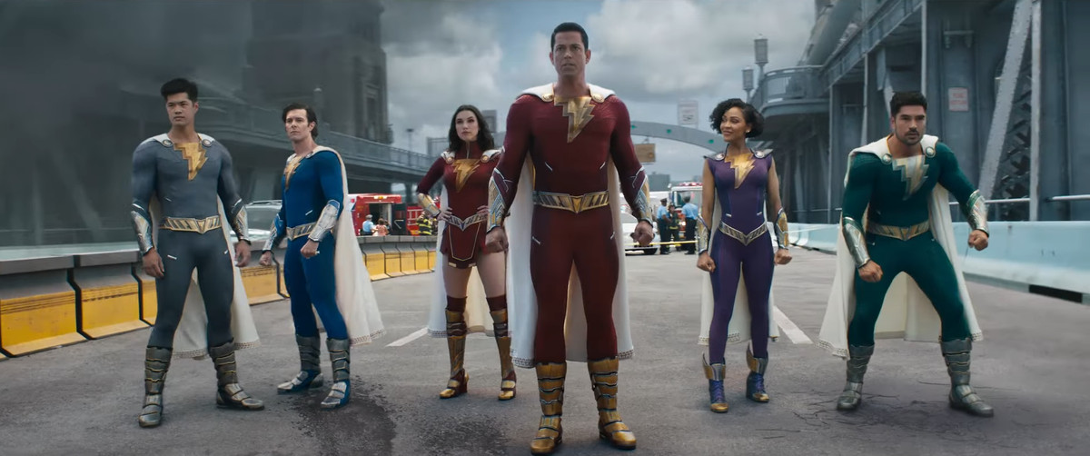Zachary Levi as Shazam in Shazam! Fury of the Gods standing with the rest of his superhero family