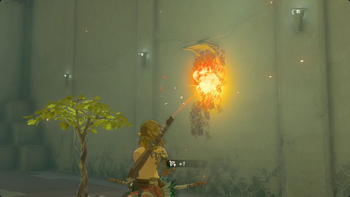 The Legend of Zelda: Tears of the Kingdom Link using a fire fruit Fused to an arrow to light vines on fire in Nouda Shrine.