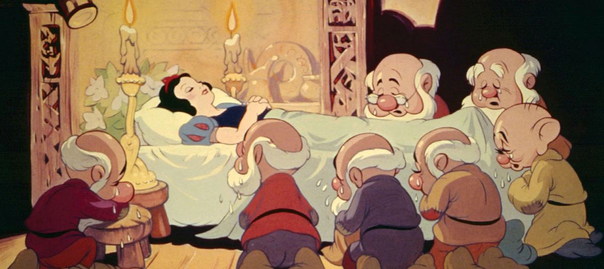 A painted cel of the seven dwarves weeping at the bedside of a sleeping Snow White.