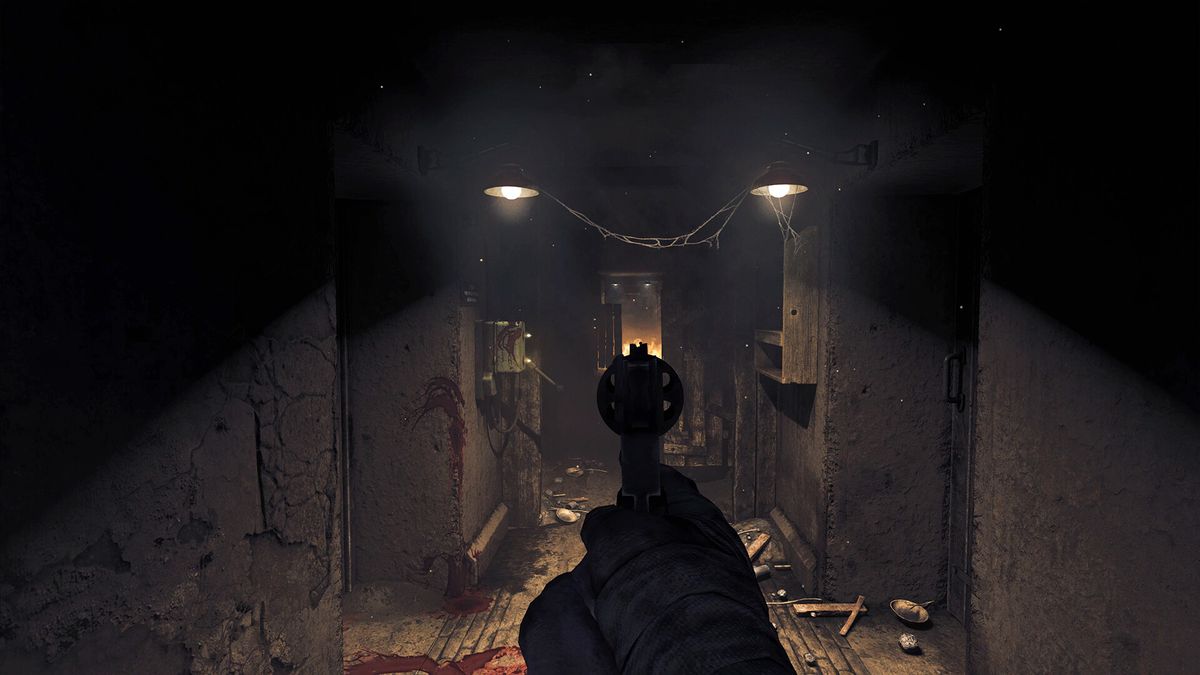 The protagonist aims down the sights of his pistol in a corridor in Amnesia: The Bunker
