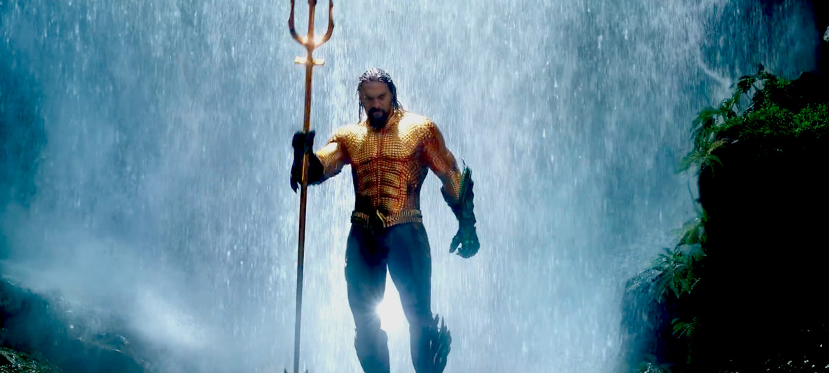 Aquaman - Aquaman holding a trident standing in front of a waterfall