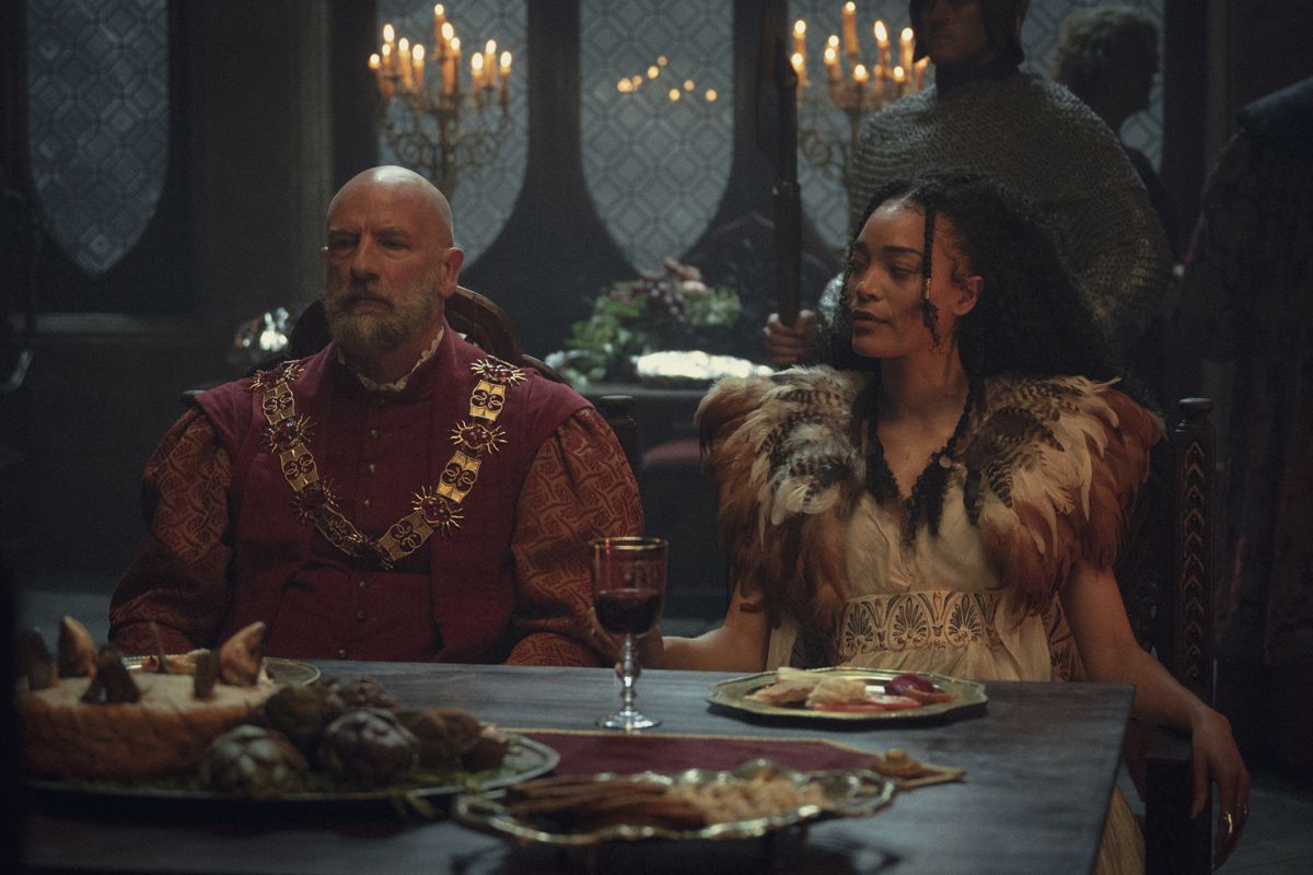 Dijkstra (Graham McTavish) and Philippa (Cassie Clare) at a banquet in The Witcher season 3