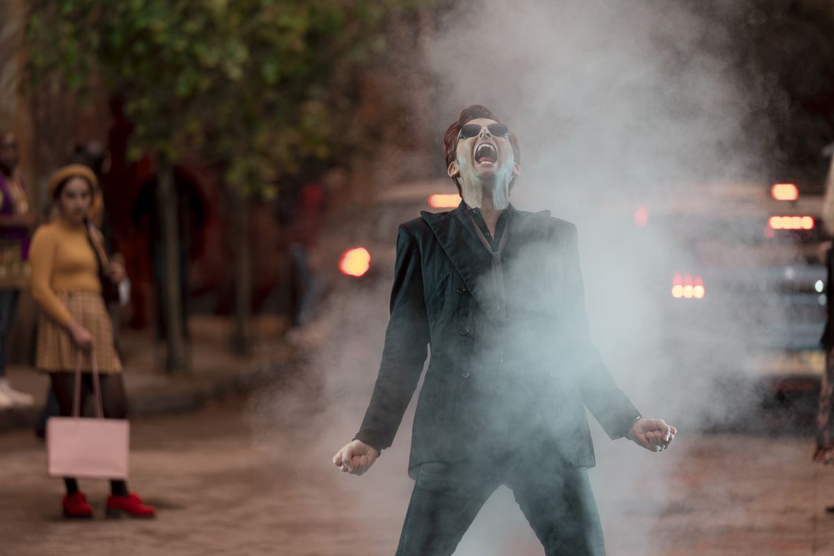 David Tenant as Crowley the demon, literally smoking in the middle of the street