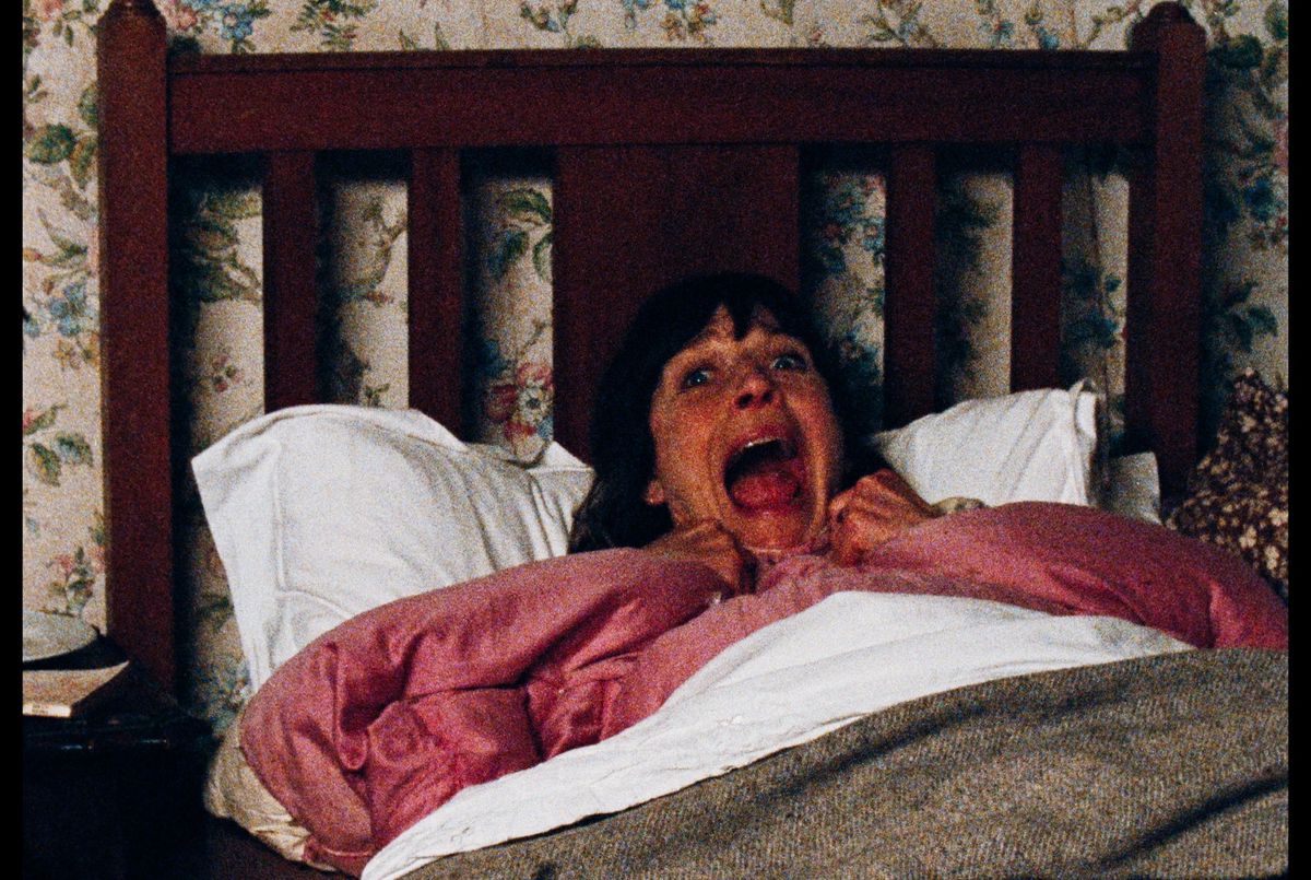 A woman (Mary Woodvine) screaming in her bed in Enys Men.
