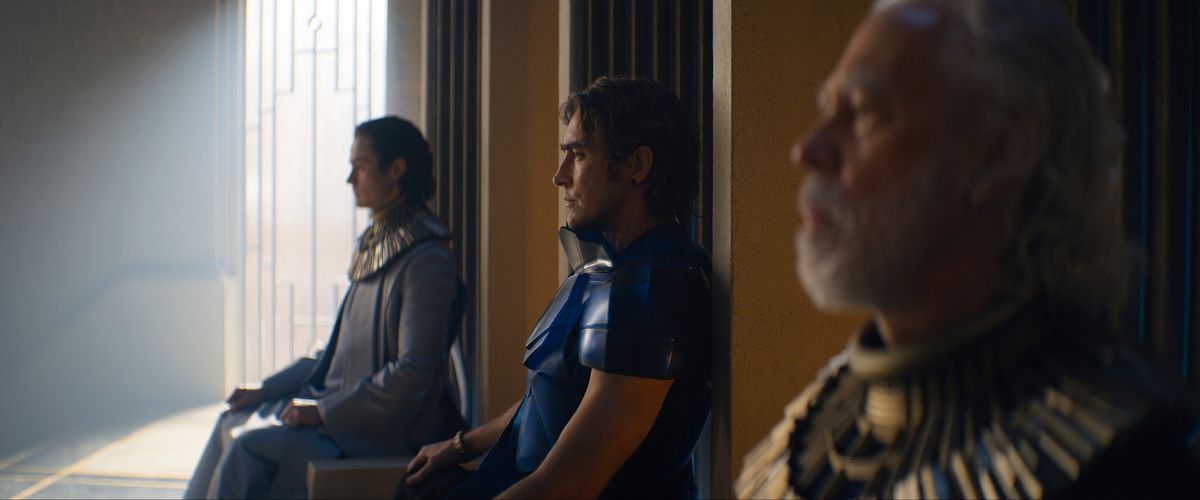Brothers Dawn (Cassian Bilton), Day (Lee Pace), and Dusk (Terrence Mann) sitting on their thrones in a still from Foundation season 2