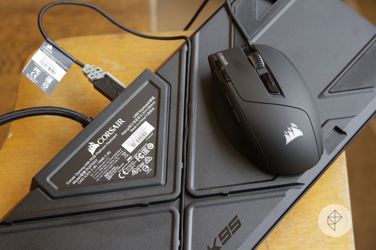 A photograph shows a Corsair mouse on a mechanical keyboard